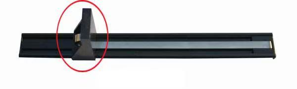 Shelf pusher example with an upright pusher plate and a metal strip extending along a black track; the pusher area is circled in red.